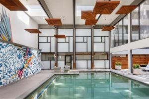 an indoor pool in a building with glass ceilings at Hotel Mockingbird, Dallas, a Tribute Portfolio Hotel in Dallas