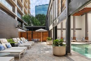 a patio with lounge chairs and a pool in a building at Hotel Mockingbird, Dallas, a Tribute Portfolio Hotel in Dallas