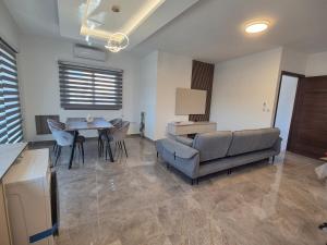 a living room with a couch and a table at AK Appartment in Kato Pyrgos