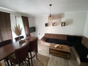 a living room with a couch and a table at Vikendica sa bazenom in Višegrad