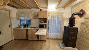 a kitchen with wooden cabinets and a stove at Little H Family in Dealu Mare +24 photos