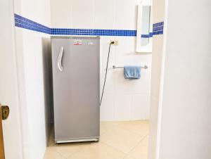 a refrigerator in a bathroom with a tile wall at Best View 2 Adults Only in La Laguna