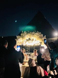 a group of people sitting at a table at night at Comfort Pyramids Inn in Cairo