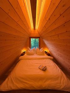 a bed in a small room with a window at Lune Dunakanyar in Esztergom