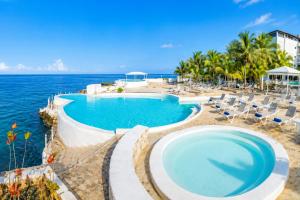 a pool with chairs and the ocean in the background at Best View 2 Adults Only in La Laguna +6 photos
