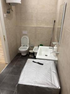a bathroom with a toilet and a sink at SL Apartment in Tirana