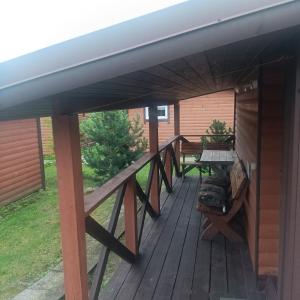 a deck with awning and a table on it at Liepsna Šventoji in Šventoji