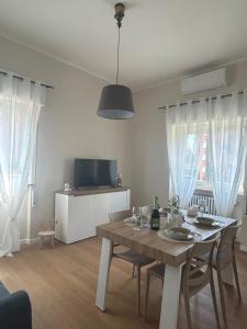 a dining room with a table with wine glasses on it at Maris Home in Luino