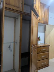 a room with a closet with wooden cabinets at New Beginnings in Salisbury +6 photos