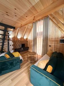 a room with two beds and a couch in a room at Alvearium Chalets in Žabljak