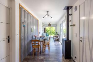a hallway with a dining room with a table and chairs at Le Container de Jeff - Maison bois, grand jardin in Uzel +11 photos
