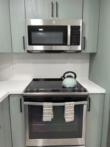 a kitchen with a stove with a tea pot on it at cozy bohemian in North Miami
