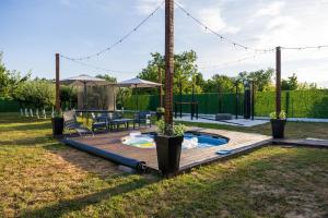 a backyard with a pool and a playground at Kuća za odmor Fjaka in Sotin