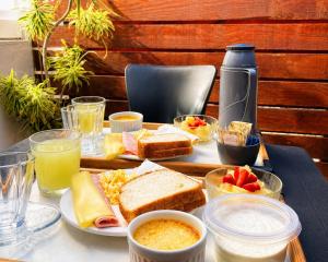 a table with a tray of breakfast foods and drinks at Casa Estelar in Cabo Frio