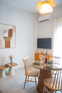 a living room with a table and chairs and a tv at Boho Nook Apartment in Rethymno