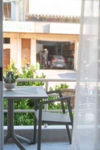 a table and a chair sitting on a balcony at Boho Nook Apartment in Rethymno