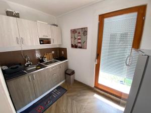 a small kitchen with a sink and a window at Vikendica sa bazenom in Višegrad