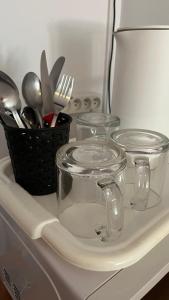 three glass containers sitting on top of a kitchen counter at Jagienka in Łeba +18 photos