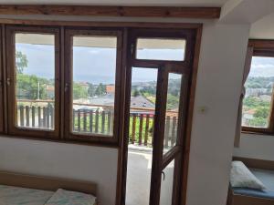 a room with doors and windows with a view at Атлас in Byala +13 photos