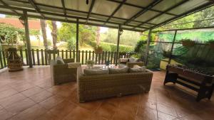 a screened in porch with couches and a fish tank at Vila Marija in Podgorica