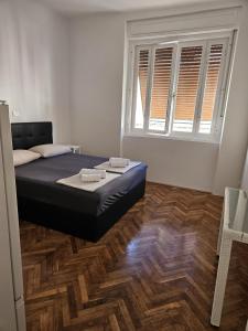 a bedroom with a bed and a large window at Sonček 2 in Izola