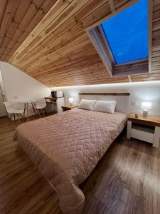 a bedroom with a large bed with a large window at Lukas Hotel in Muravitsa +8 photos