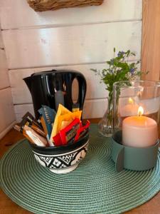 a table with a candle and a candle holder on a table at opplevelses hytta badestamp ridning osv in Skien
