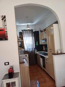 a small kitchen with an archway in a room at Luna in Novara +3 photos