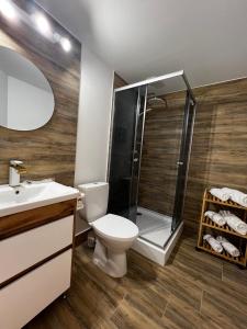 a bathroom with a shower and a toilet and a sink at Lukas Hotel in Muravitsa