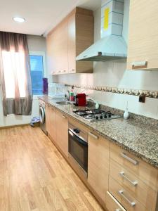 a kitchen with a stove top oven next to a window at super appartement centre avec parking in Tangier