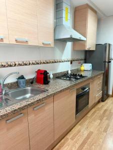 a kitchen with a sink and a stove at super appartement centre avec parking in Tangier +7 photos