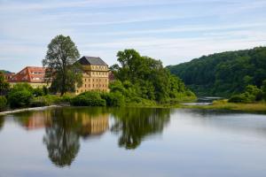 a large building sitting on top of a river at Altstadtquartier Grimma in Grimma