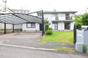 an empty parking lot in front of a house at Fuka in Beppu -New Open January2026 in Beppu