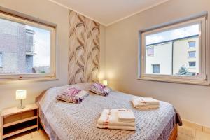 a bedroom with a bed with two pillows on it at Villa Arkodes in Gdańsk