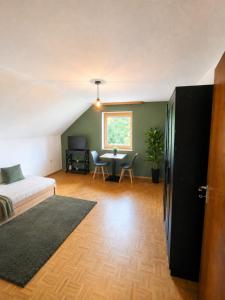 a living room with a couch and a table at Jagdhaus am Neubäuer See in Roding