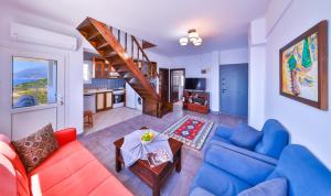 a living room with a couch and a table at Panaroma Meis Suits in Kaş