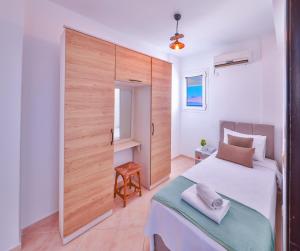 a bedroom with a bed and a sliding door at Panaroma Meis Suits in Kaş +90 photos