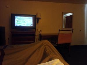 a hotel room with a television and a bed at Knights inn hotel in Jacksonville