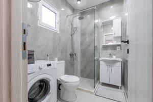 a bathroom with a washing machine and a shower at Apartmani Oleander in Bar +25 photos