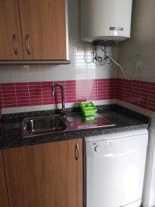 a kitchen with a sink and red tiles at Velez Nazari Cambriles in Lújar