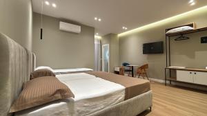 a hospital room with a bed and a tv at Gysi`s Hotel & Restaurant - Near Tirana in Tapizë