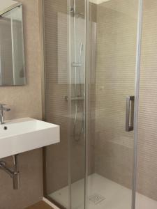 a bathroom with a shower and a sink at Lentamente Domo in San Giovanni +18 photos