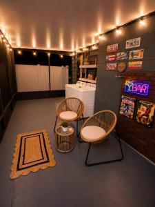 a room with two chairs and a table and a rug at The Cozy Corner House in Kissimmee