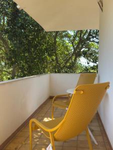 two chairs and a table on a balcony at Lentamente Domo in San Giovanni