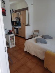 a bedroom with a bed and a kitchen with a table at Luna in Novara