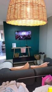 a living room with a couch and a flat screen tv at NAT home in San Lorenzo