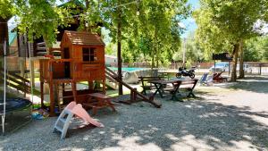 a playground with a tree house and a picnic table at Laki House Skadar lake in Železnička Stanica Zeta +3 photos