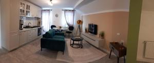 a living room with a green couch and a table at Casa A&A Stefan Livada in Livada