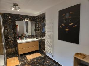 a bathroom with a sink and a mirror at Apartmán Horský park in Bratislava