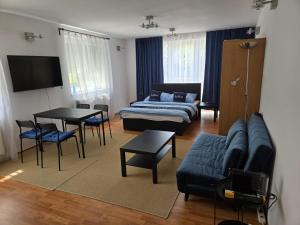 a living room with a couch and a table at Apartmán Horský park in Bratislava
